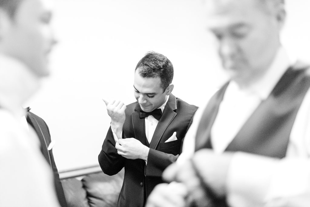 groom getting ready between brother in law and father in alw