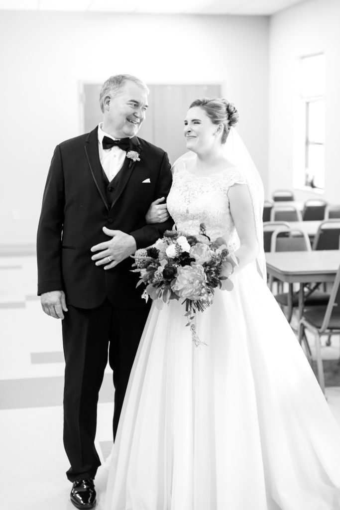 bride and father before they walk down the aisle at Immaculate Conception church in Eau Claire