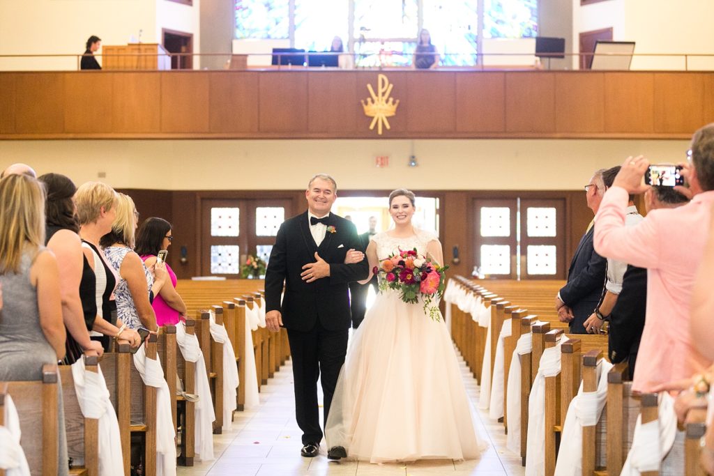 bride and father walking down the aisle at Immaculate Conception in Eau Claire