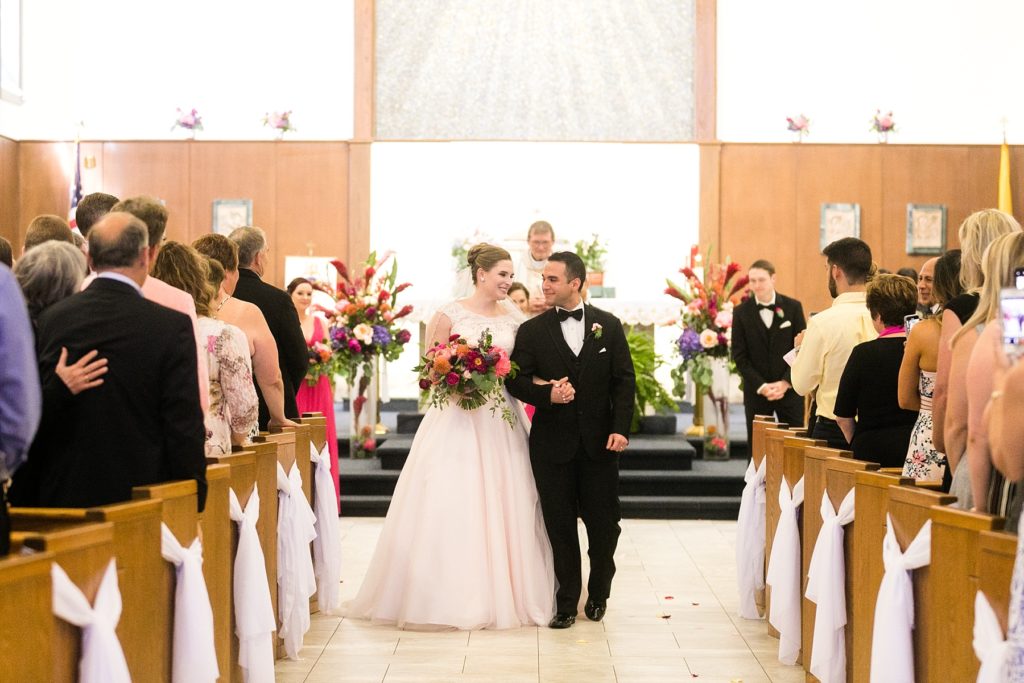 couple in recessional at Immaculate Conception in Eau Claire