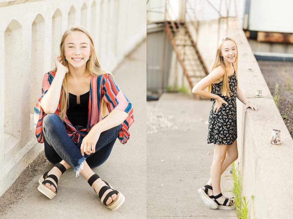 girl sitting on a bridge and laughing at the camera for her Eau Claire boho senior photos
