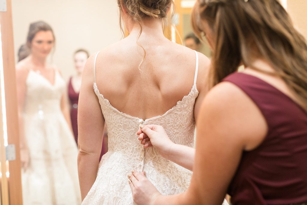 bride getting zipped into her gown for her Wisconsin Dells wedding