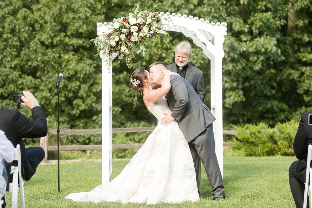 bride and groom's first kiss during the ceremony at the Glacier Canyon Conference Center for a wedding at the Wilderness Resort in Wisconsin Dells