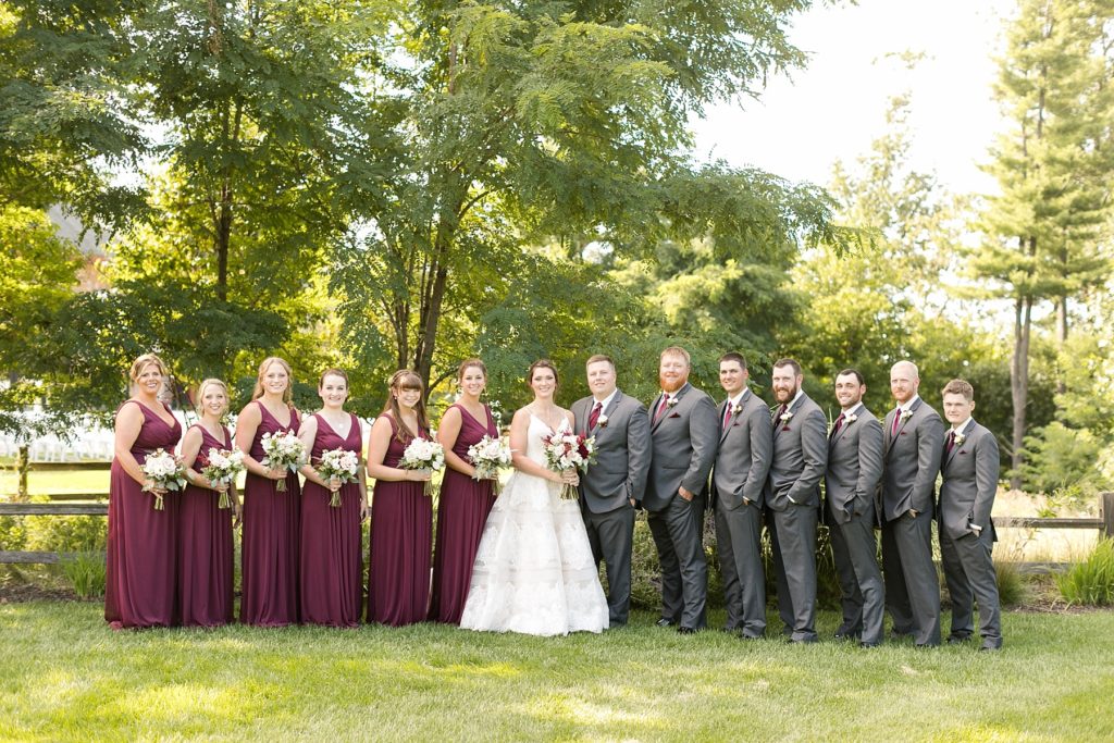 bridal party in burgundy and grey at the Glacier Canyon Conference Center for a wedding at the Wilderness Resort in Wisconsin Dells