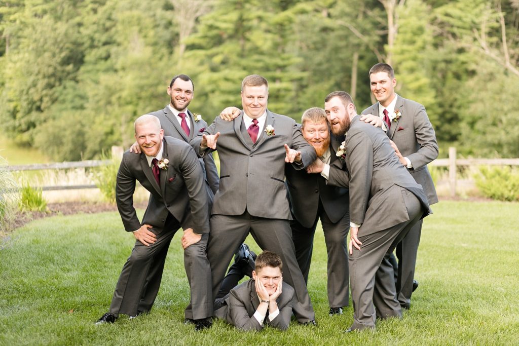 groom and groomsmen in a silly photo at the Glacier Canyon Conference Center for a wedding at the Wilderness Resort in Wisconsin Dells