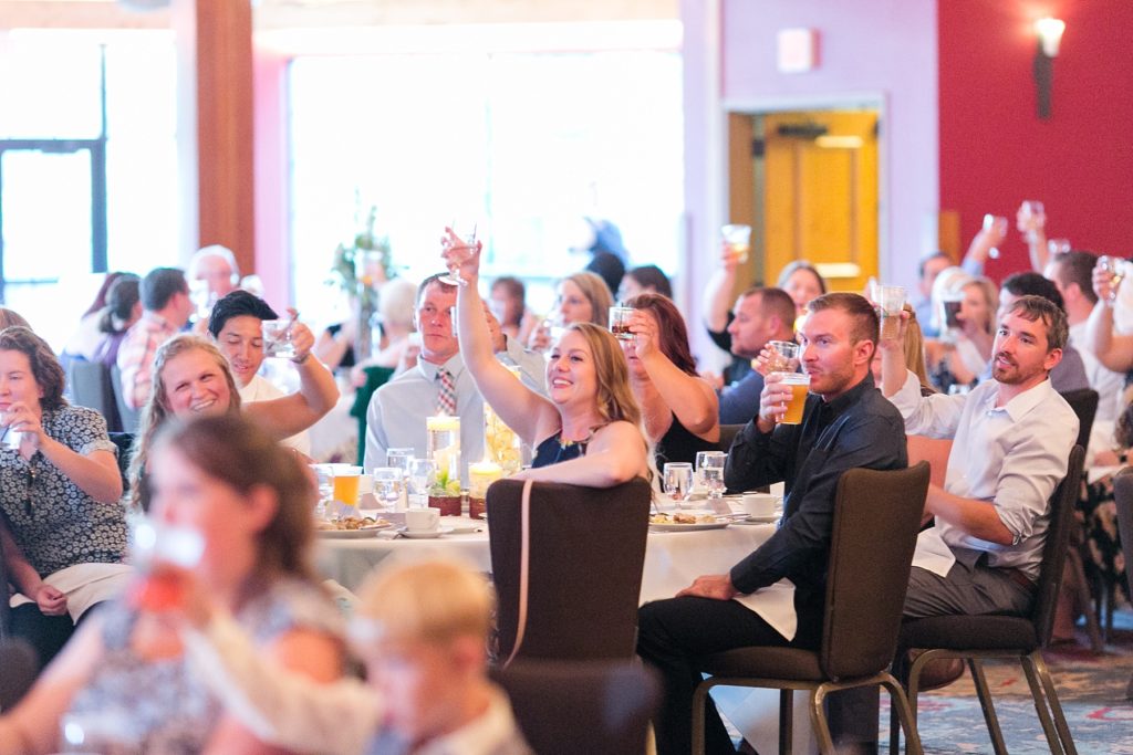 guests with their glasses raised at the Glacier Canyon Conference Center for a wedding at the Wilderness Resort in Wisconsin Dells