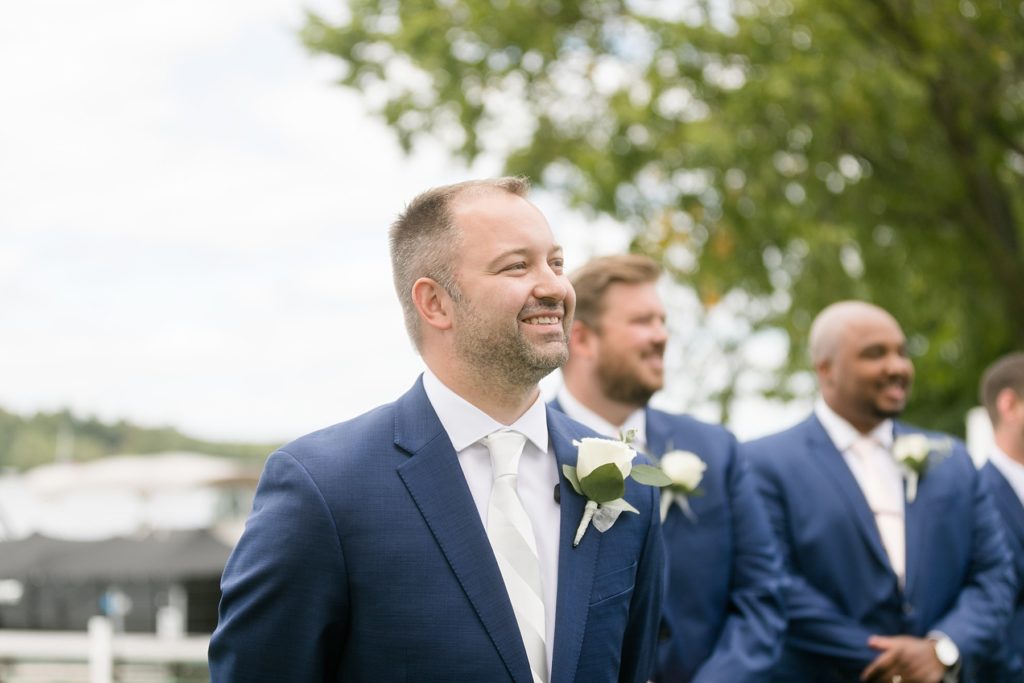 groom seeing the bride walking down the aisle for the first time at Lake Wissota Golf & Events