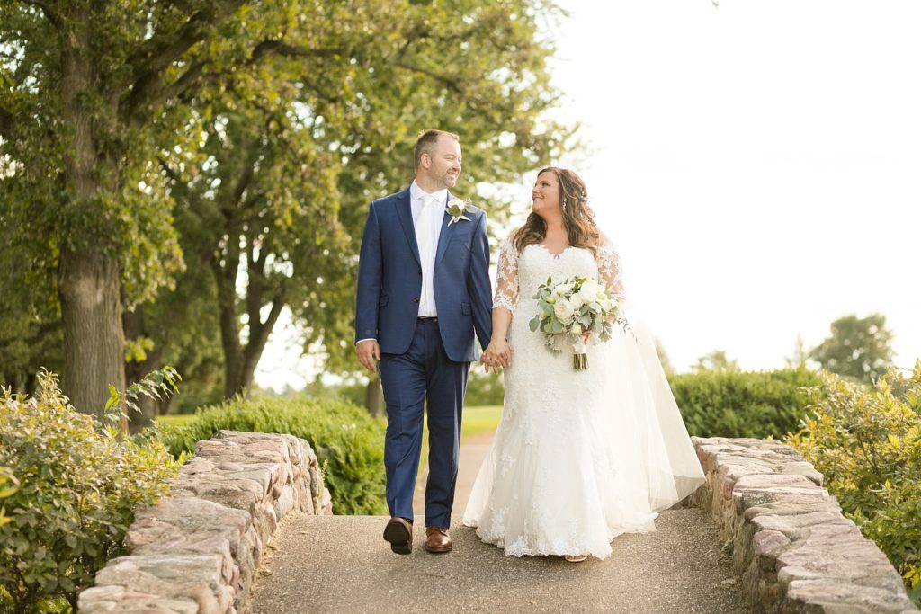 couple on the stone bridge at Lake Wissota Golf & Events