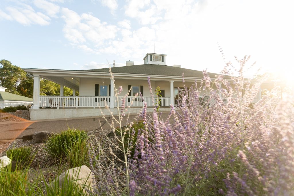Lake Wissota Golf & Events in August with the sun coming over a purple bush