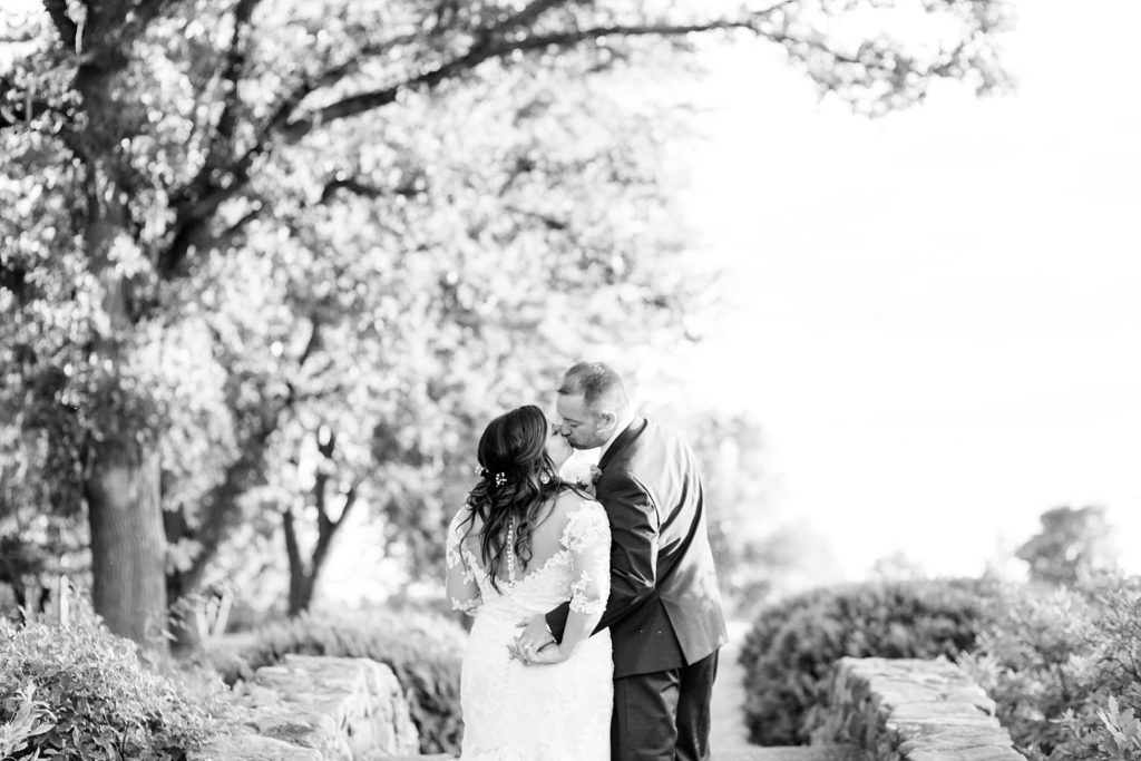 couple kissing with their back to the camera at Lake Wissota Golf & Events