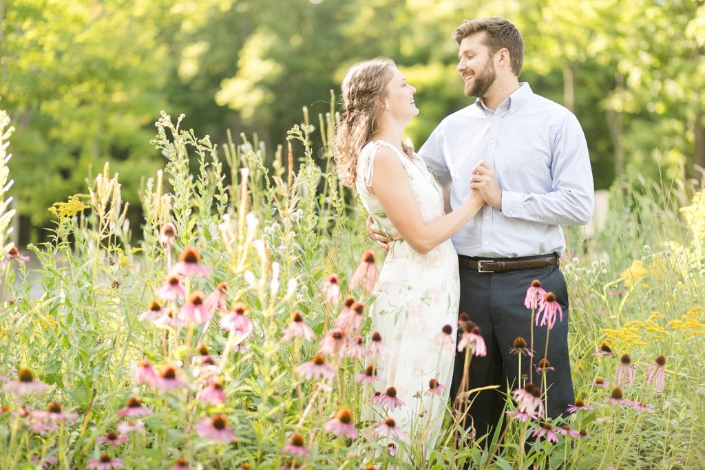 couple in a field of flowers in Rib Mountain State Park in Wausau for their engagement pictures