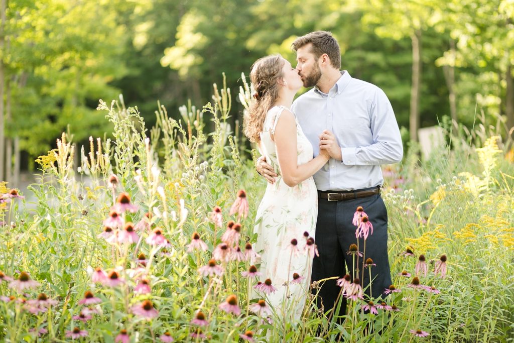 couple kissing in flowers at Rib Mountain State Park in Wausau for their engagement pictures