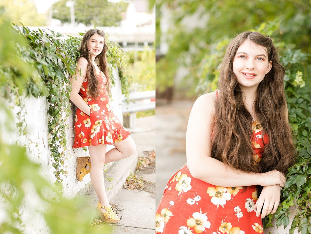 girl in downtown Bloomer leaning on a vine covered wall for her Cadott High School senior photos