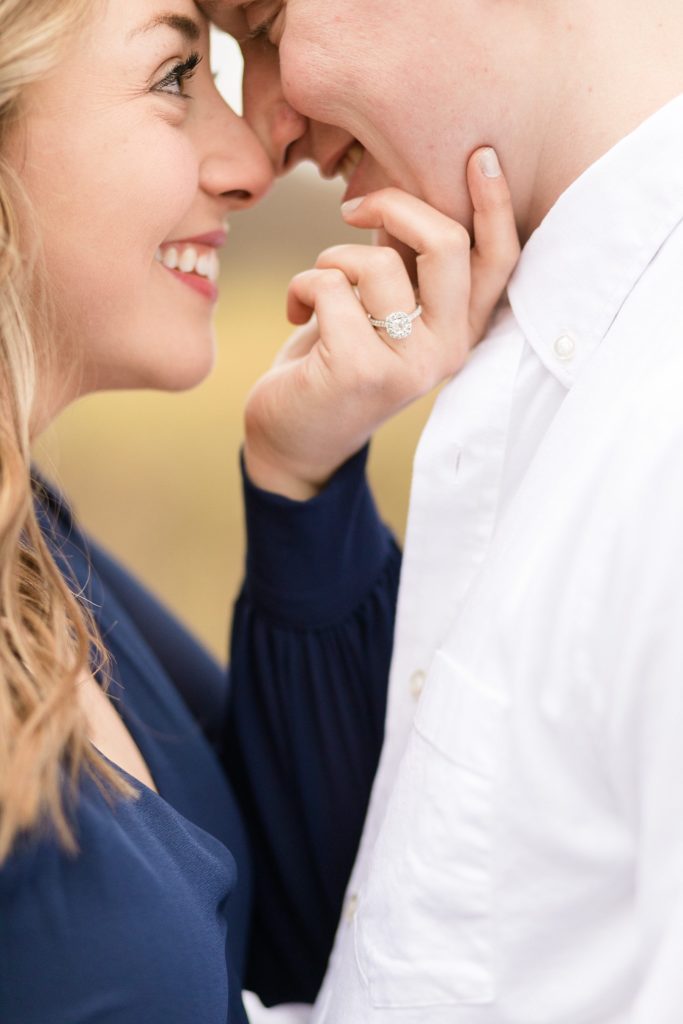 Couple nose to nose with engagement ring in their Eau Claire engagement session.