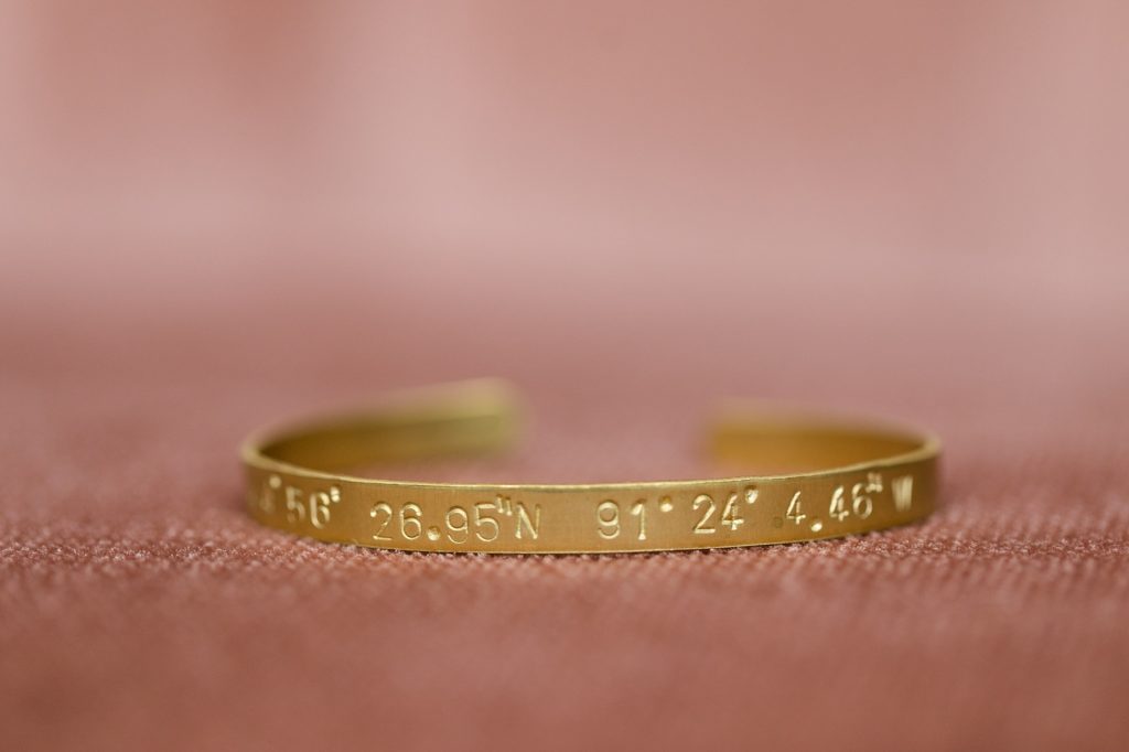 bangle made by Sela Designs in Wisconsin with coordinates of the church where the couple were married