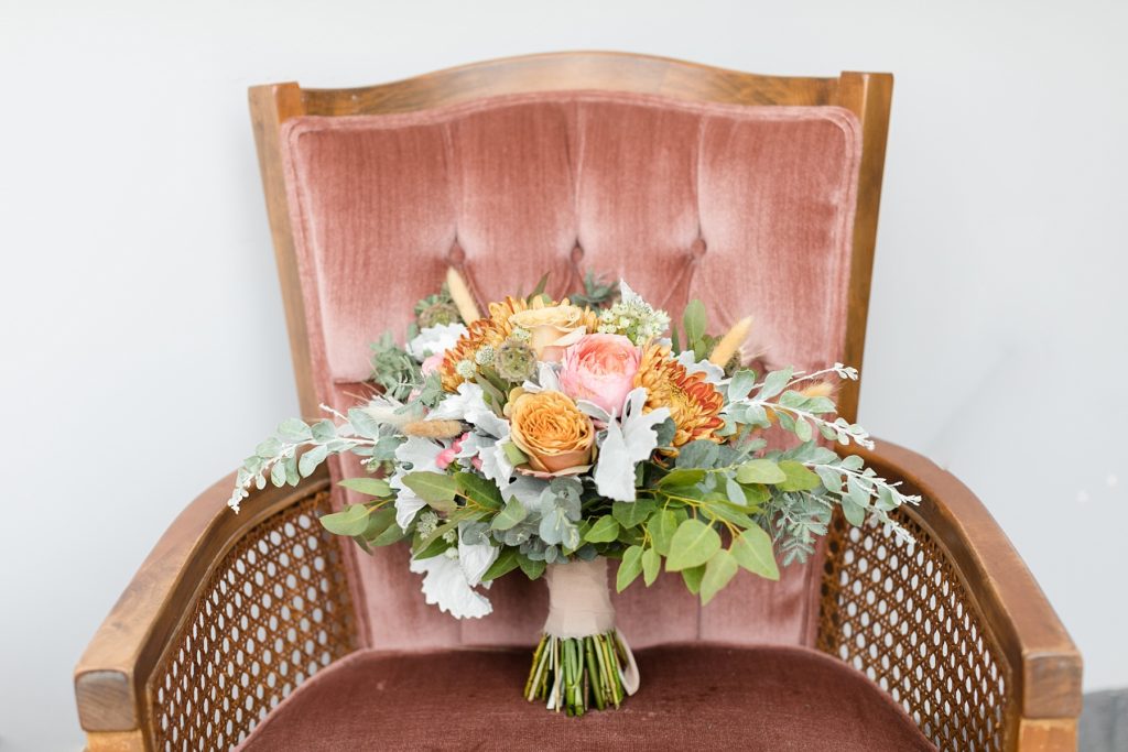 brides bouquet on a pink velvet chair in a church in Chippewa Falls. Bouquet by Fersk Floral Artistry