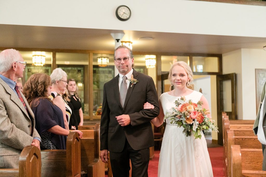 father walking daughter down the aisle at wedding at Zion United Methodist Church in Chippewa Falls