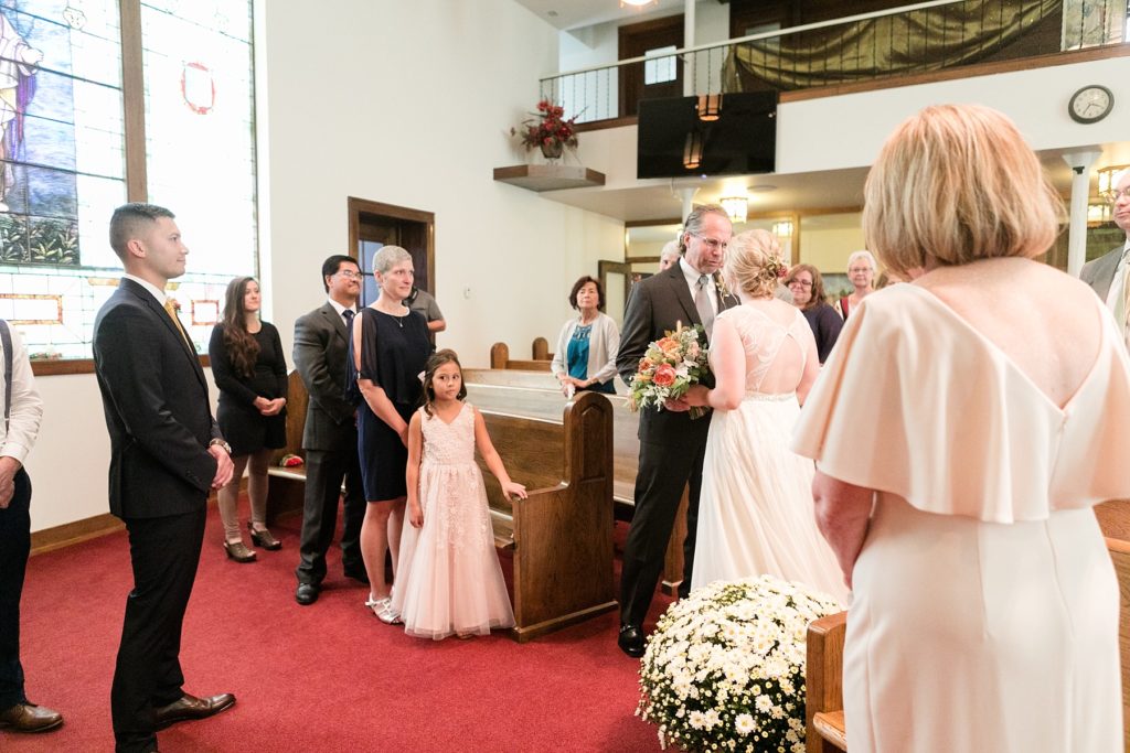 father giving daughter away at wedding at Zion United Methodist Church in Chippewa Falls
