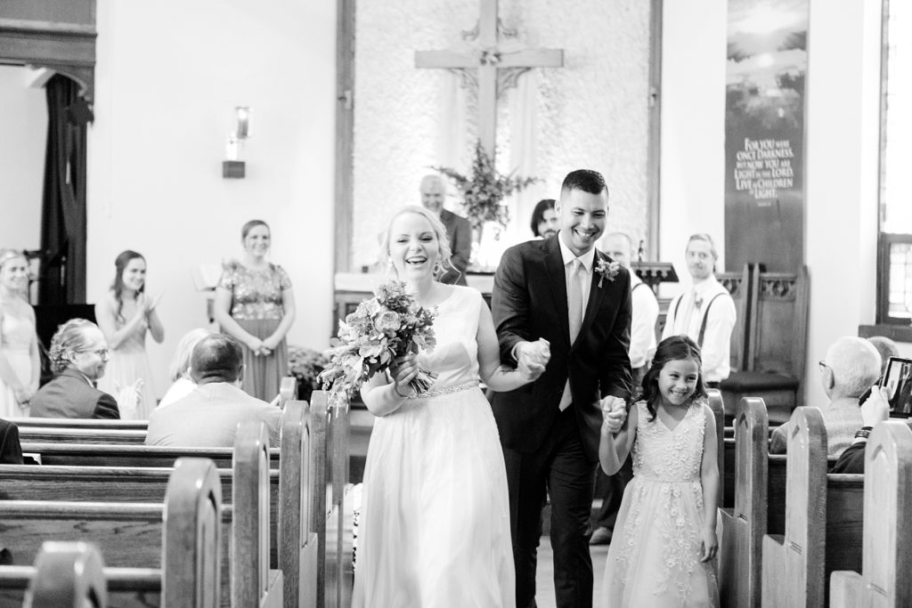 couple and daughter during recessional at wedding at Zion United Methodist Church in Chippewa Falls