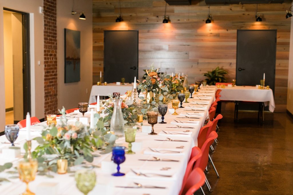 table set with floral arrangements by Fersk Floral Artistry at a wedding at the Oxbow Hotel in Eau Claire