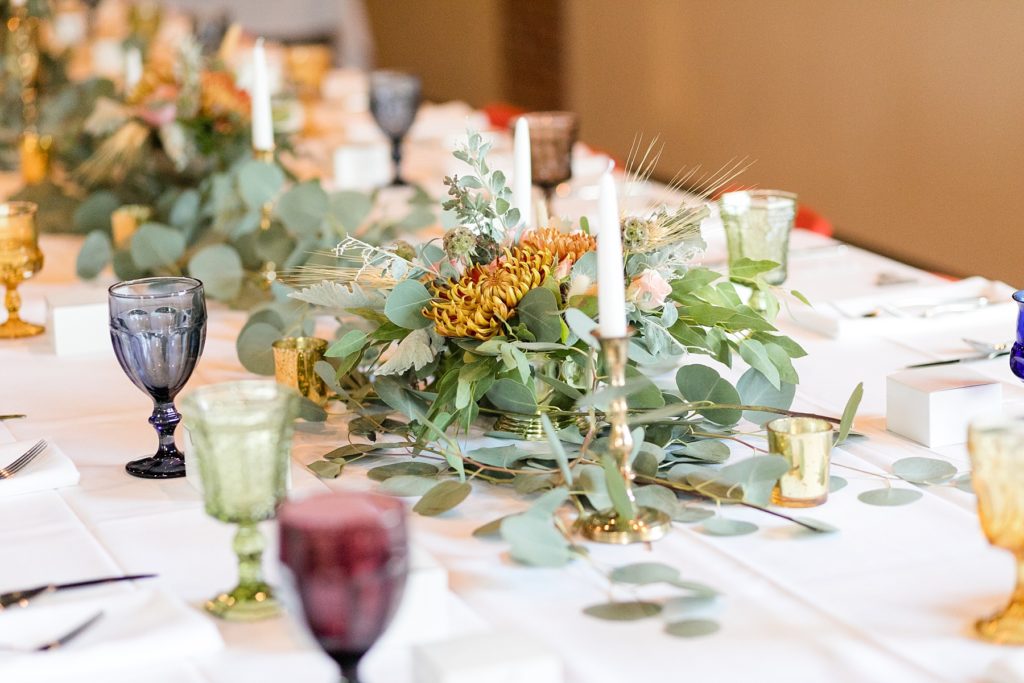 floral arrangements and goblets on the table at a wedding at the Oxbow Hotel in Eau Claire