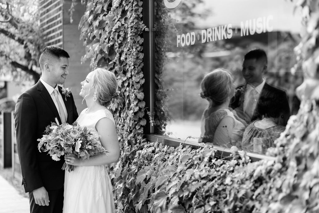 couple in a black and white photo for their wedding portraits at their wedding at the Oxbow Hotel in Eau Claire
