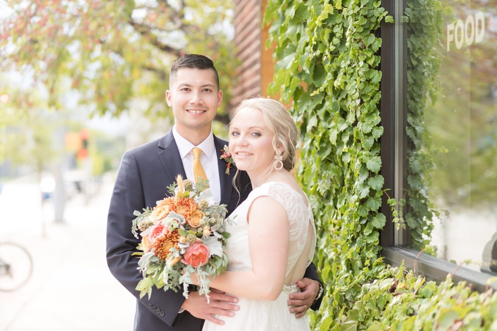 couple with vines at their wedding at the Oxbow Hotel in Eau Claire
