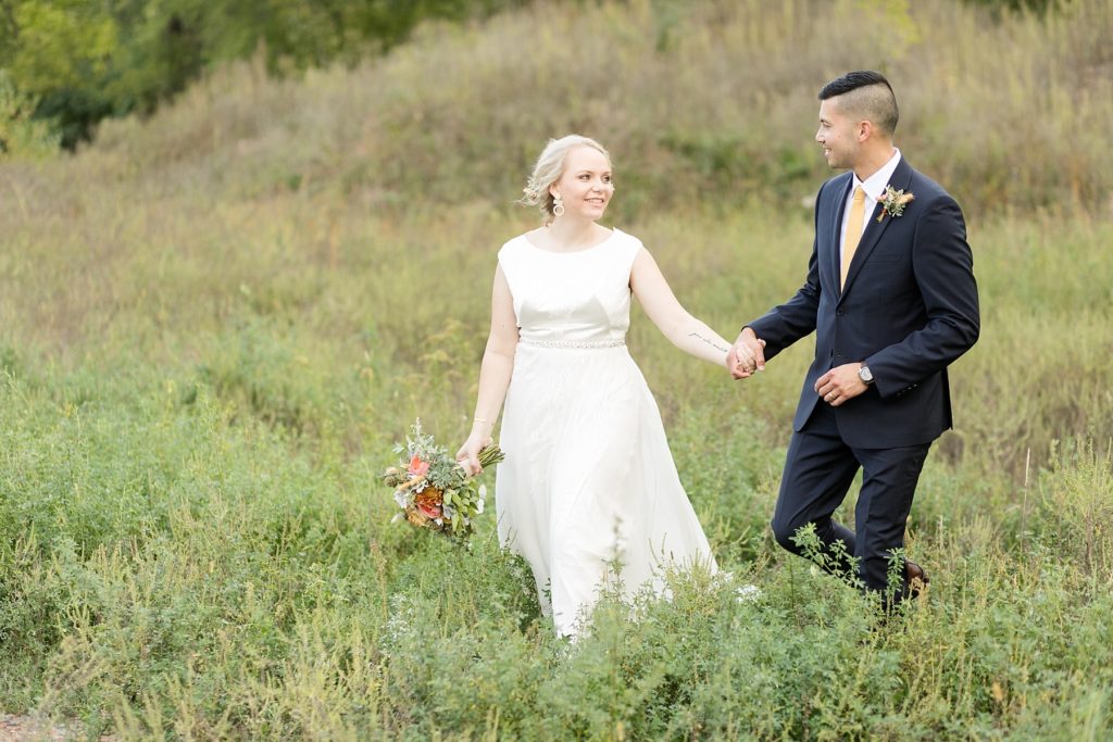 couple in a field near downtown Eau Claire on their wedding day