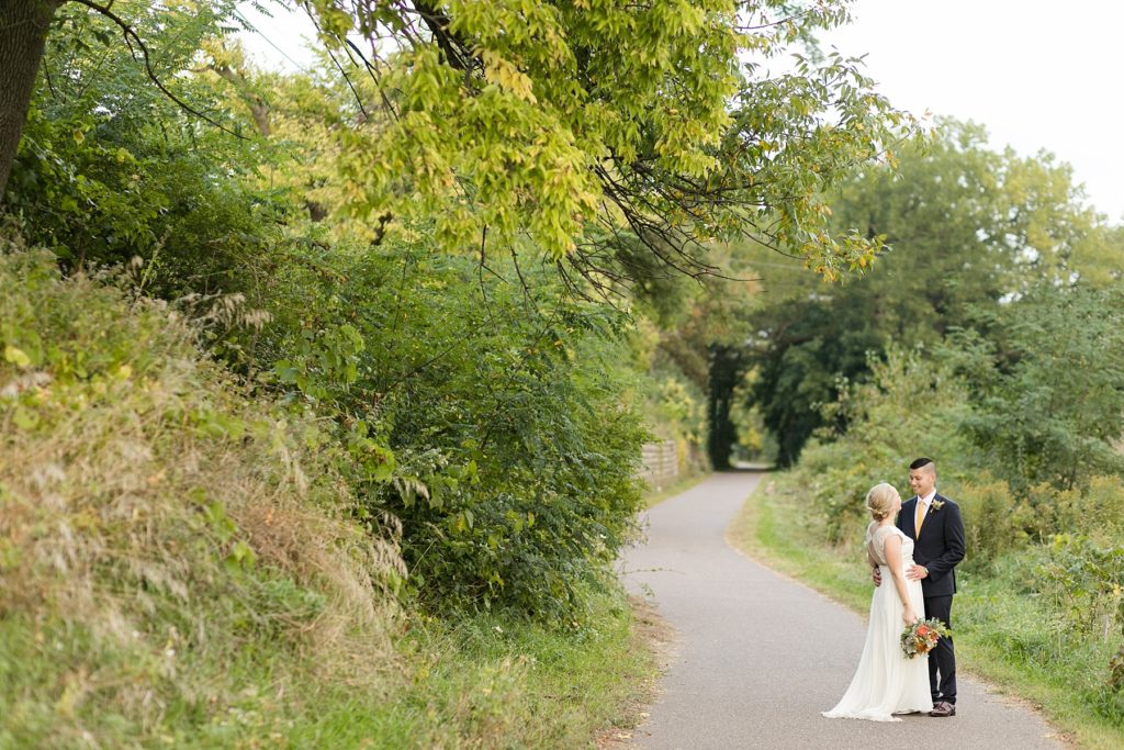 couple on the bike path in Eau Claire at their wedding at the Oxbow Hotel in Eau Claire