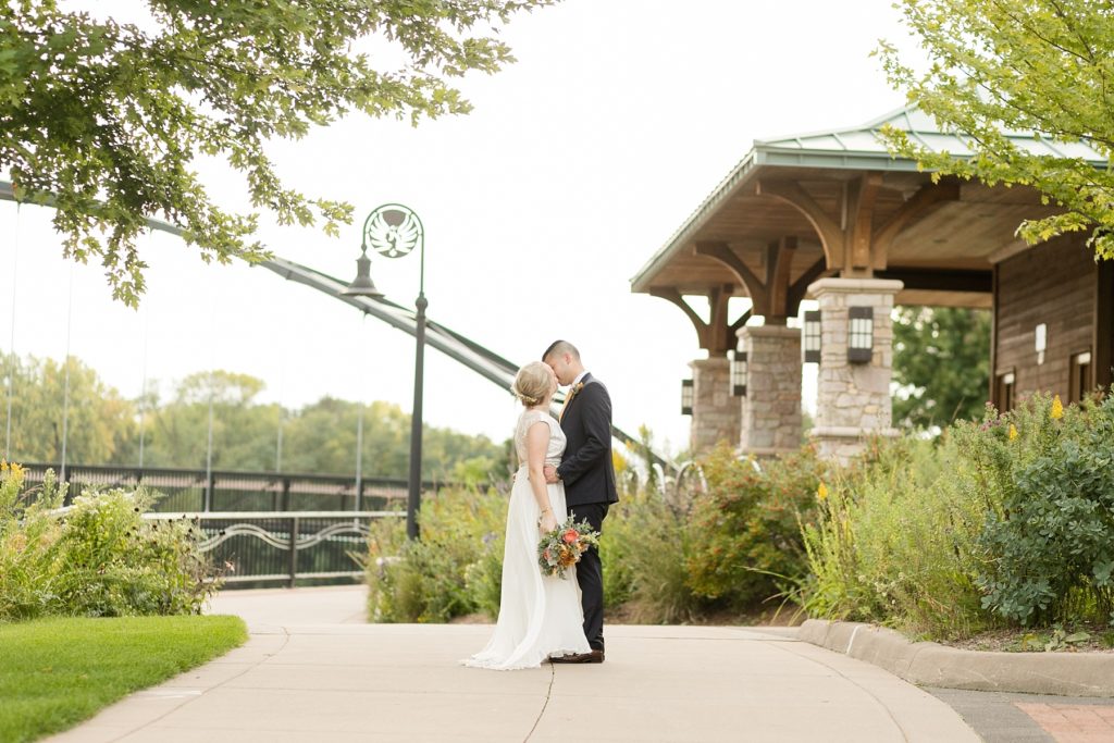 couple kissing in Phoenix Park at their wedding at the Oxbow Hotel in Eau Claire