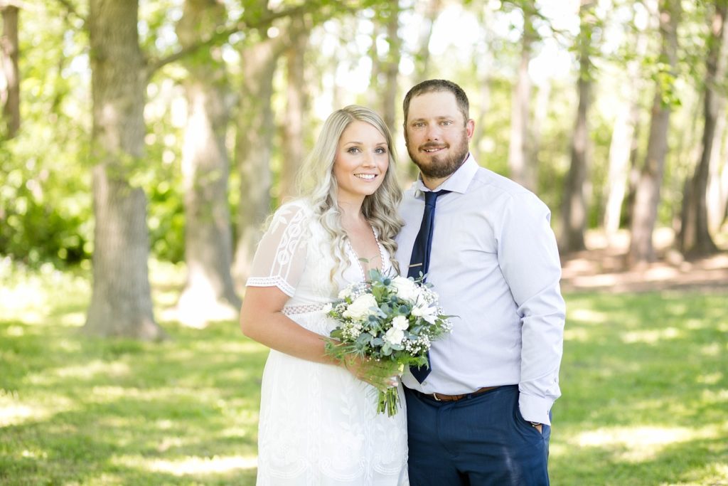 couple smiling at the camera at their Thorp Wi micro wedding