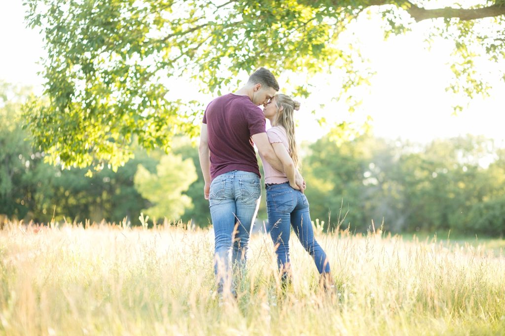 couple forehead to forehead at Willow River State Park in Hudson, WI for their engagement session