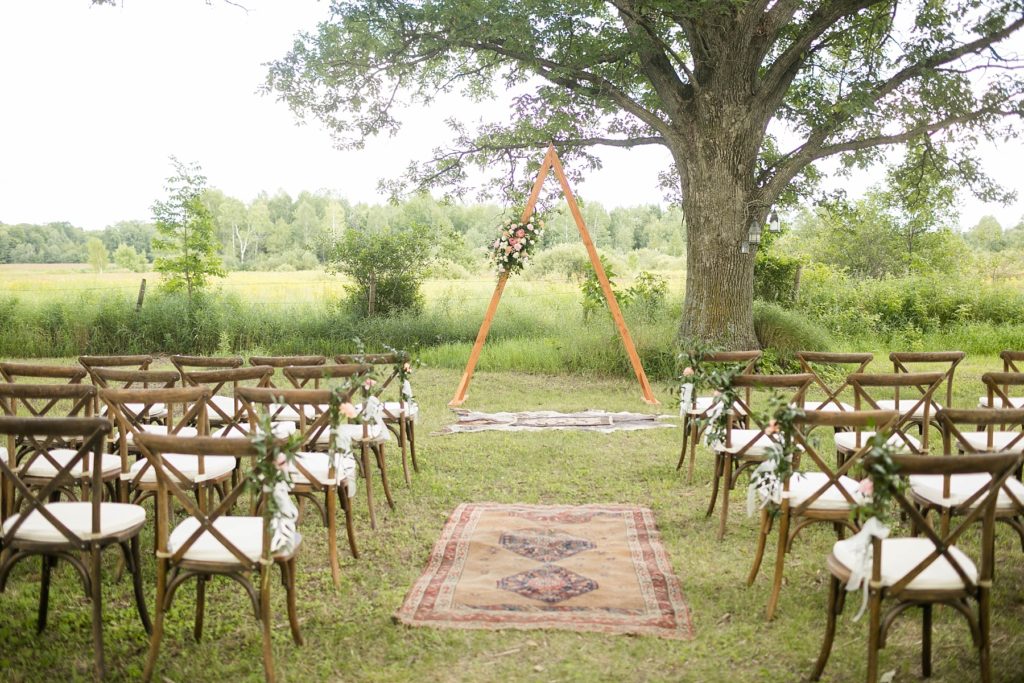 boho wedding with triangle arch and rug in Ladysmith, WI