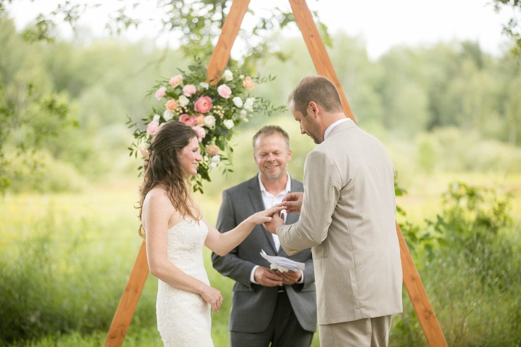 ceremony in a field intimate childhood home wedding in Ladysmith, WI 
