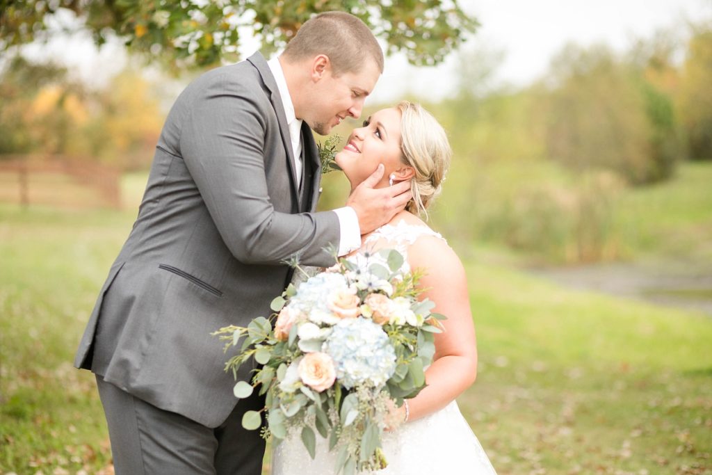 couple smile at each other at their fall wedding at Lilydale in Chippewa Falls