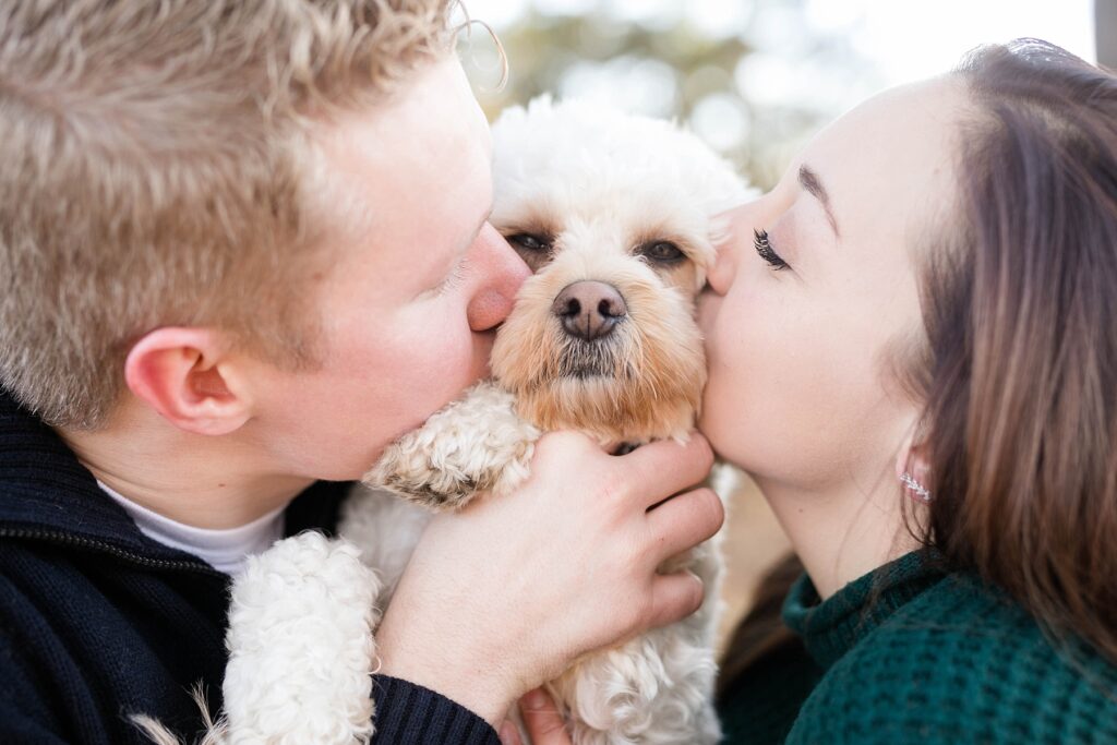 couple kissing their dog on the cheeks for an Eau Claire couple session with dog