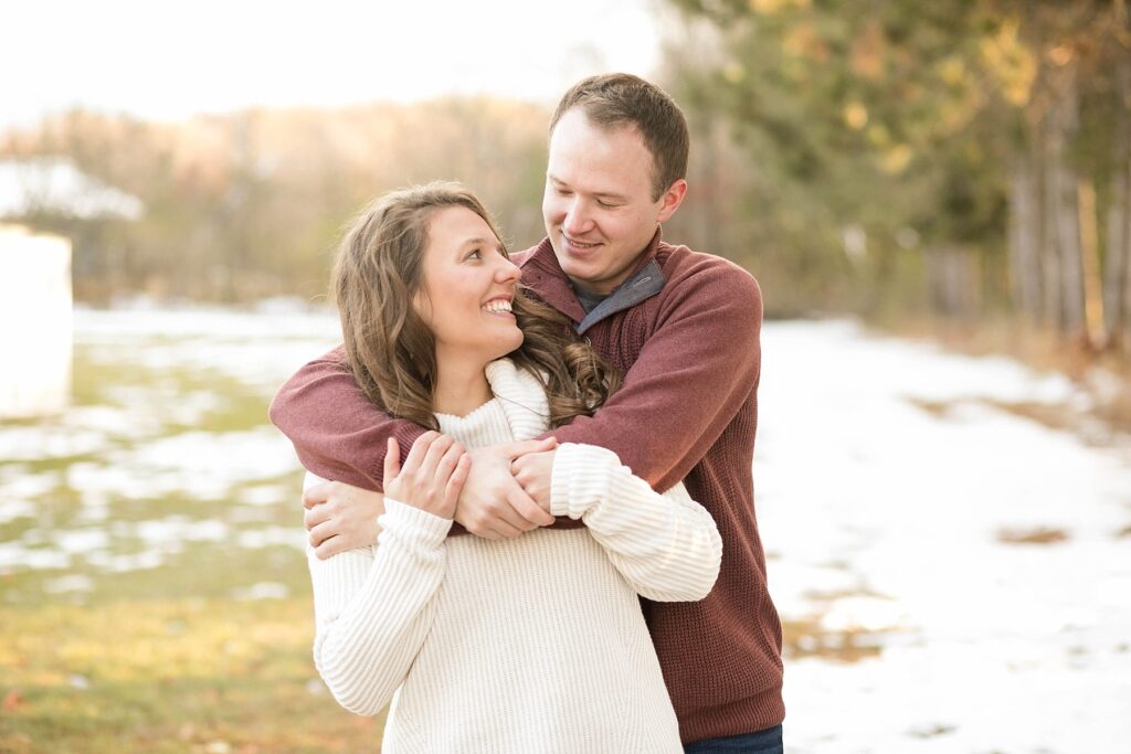 couple looking at each other for their Eau Claire couples session with new puppy