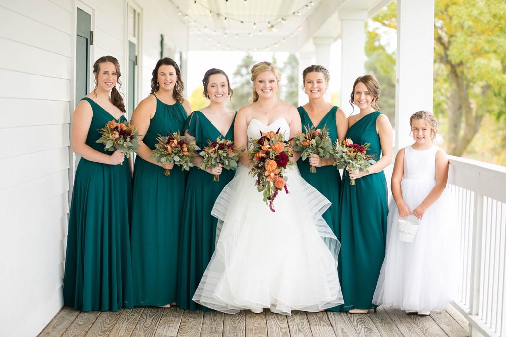 bride and bridesmaids on the deck on at a wedding at Lake Wissota Golf & Events