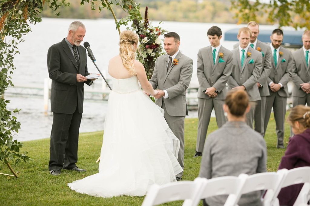 bride and groom during wedding ceremony outside on Lake Wissota at a wedding at Lake Wissota Golf & Events