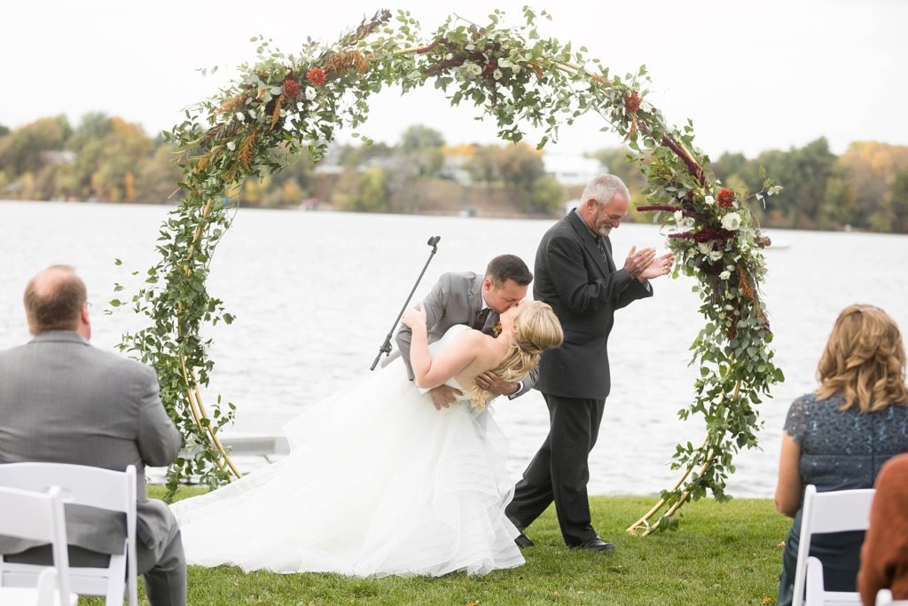 first kiss dip at a wedding at Lake Wissota Golf & Events