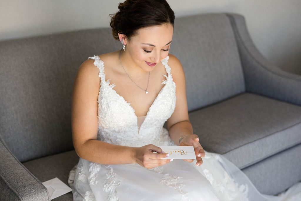 bride reading letter from the groom before her stunning wedding in Marathon, WI