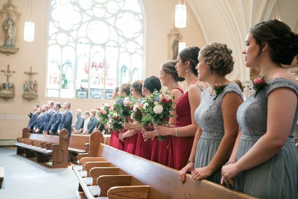 bridal party standing at stunning wedding in Marathon, WI at St. Mary's Catholic Church