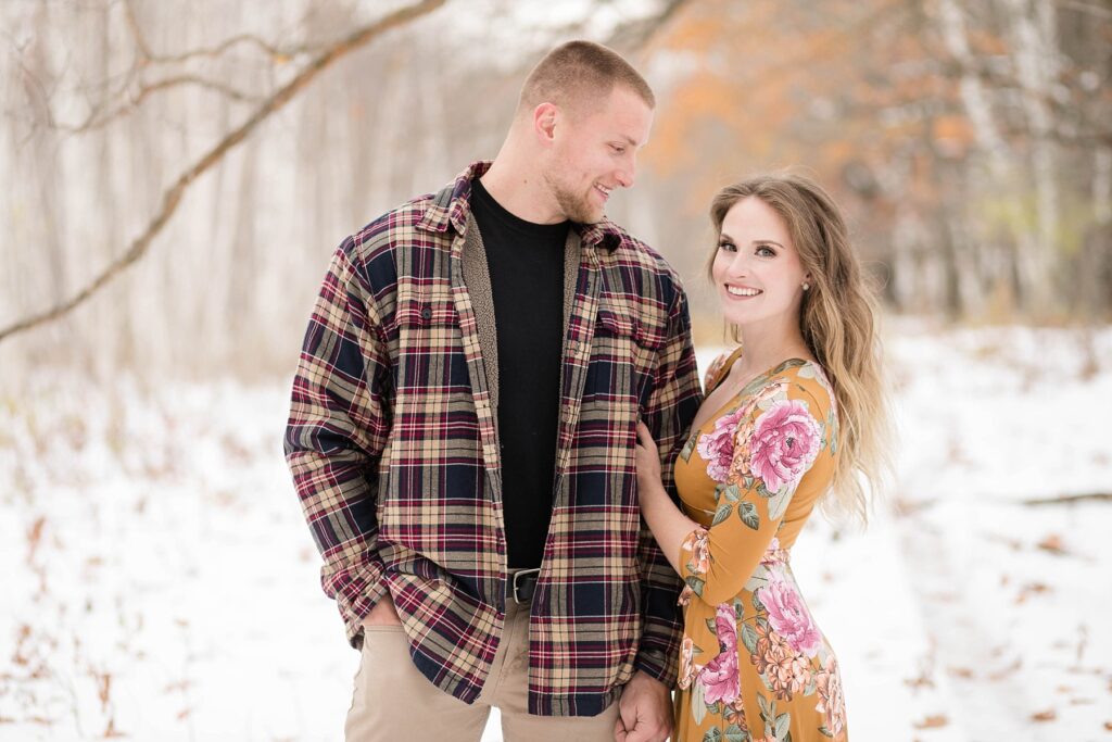 couple on a path covered in snow for their winter engagement session in Ladysmith