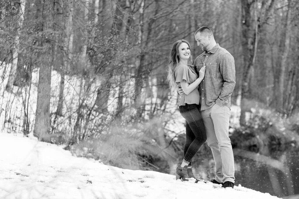 couple laughing in a black and white photo for their winter engagement session in Ladysmith
