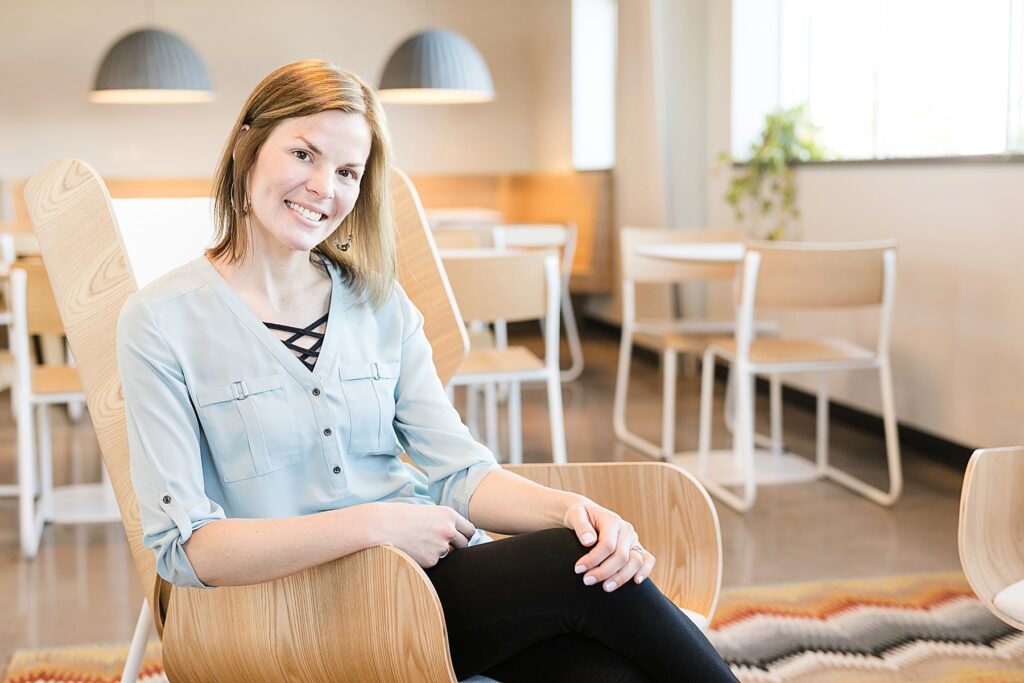 Sarah Shuda of Sarah Lynn Designs in Eau Claire, WI looks at the camera in a very modern space for her headshots.