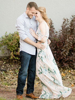 couple smiling at each other with dress blowing in the wind